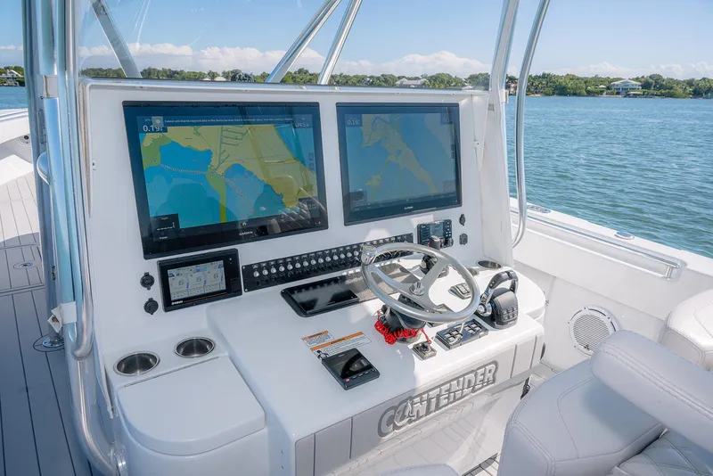 Slide: The Image of Contender 44ST 2020 boat helm with dual navigation screens on a sunny day. - 18