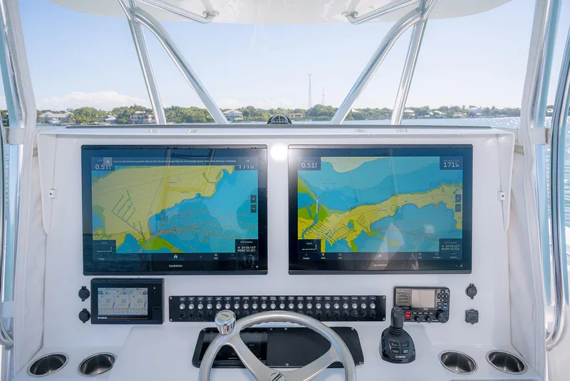Slide: The Image of 2020 Contender 44ST boat helm with dual navigation screens and controls. - 19