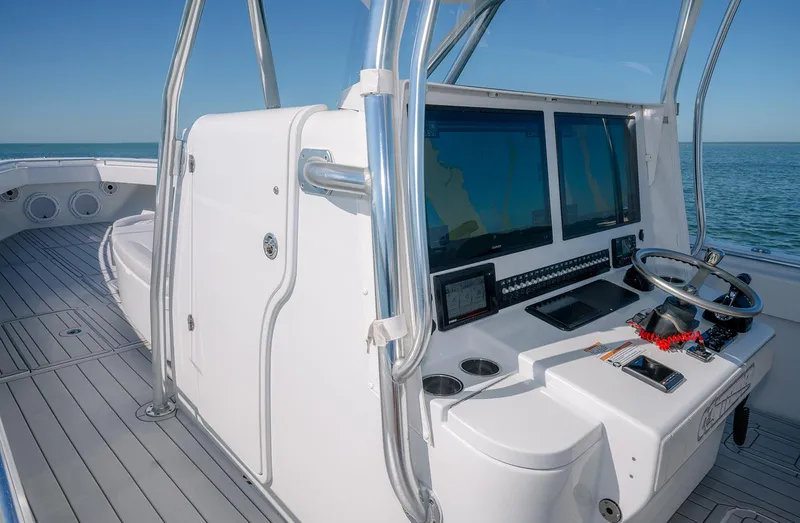 Slide: The Image of 2020 Contender 44ST boat helm with modern controls and ocean view. - 21