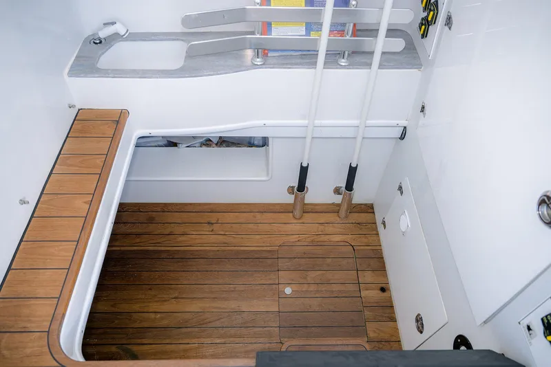 Slide: The Image of 2020 Contender 44ST boat interior with wooden flooring and storage compartments. - 23