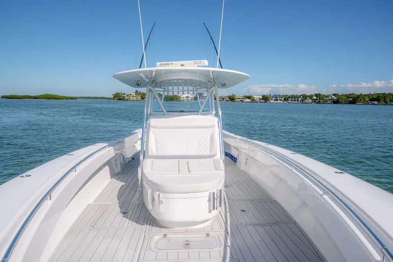 Slide: The Image of 2020 Contender 44ST boat on calm water, showcasing spacious deck and sleek design. - 25