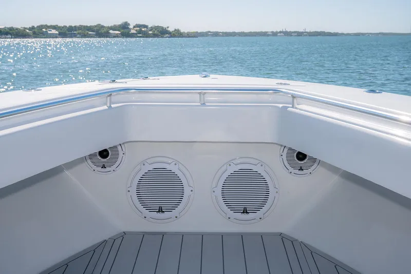Slide: The Image of 2020 Contender 44ST boat bow with speakers, overlooking calm blue waters. - 30