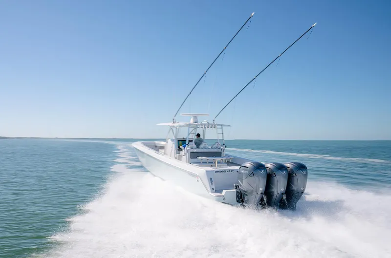 Slide: The Image of 2020 Contender 44ST boat with triple engines cruising on open water. - 5