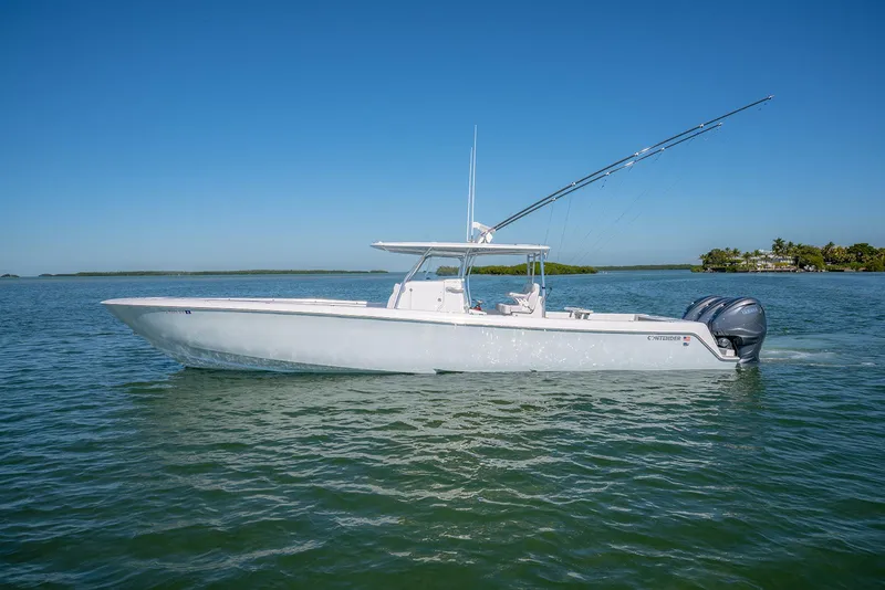 Slide: The Image of 2020 Contender 44ST boat on calm water, clear sky background. - 6