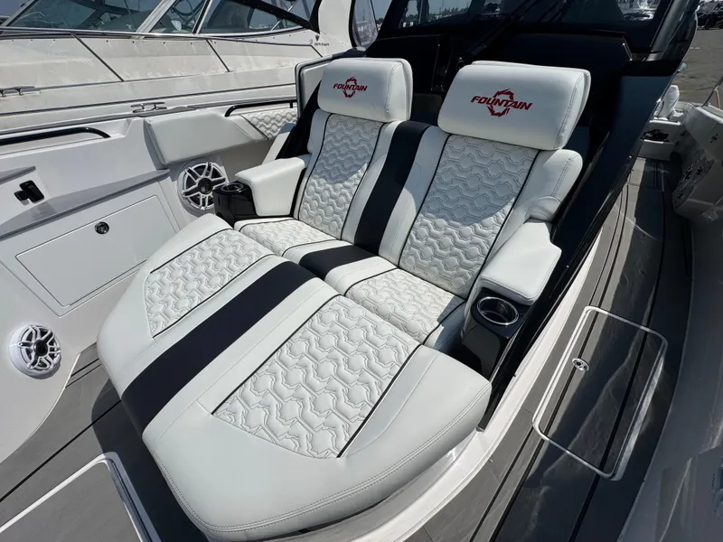 Slide: The Image of Luxury seating on 2025 Fountain 43 SCX boat, featuring premium upholstery and cup holders. - 13