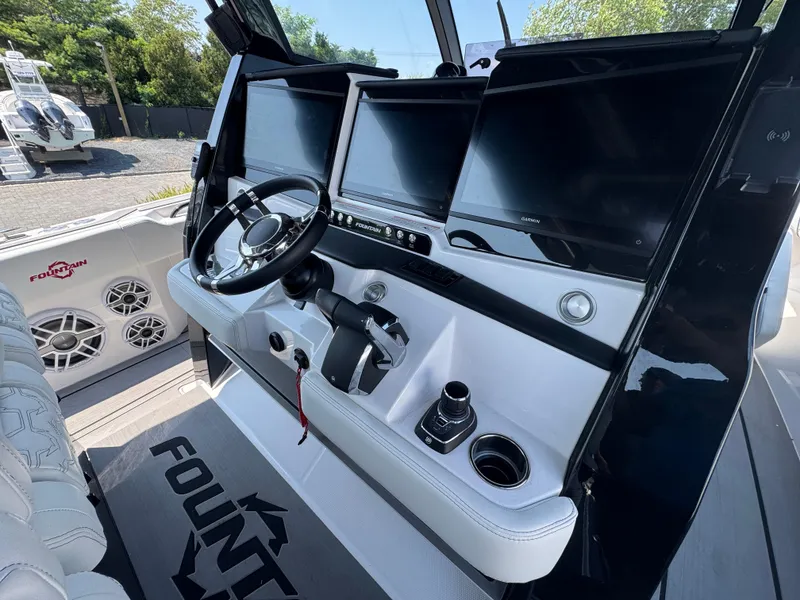 Slide: The Image of 2025 Fountain 43 SCX boat cockpit with modern steering and navigation displays. - 7