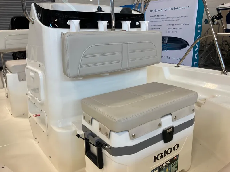 Slide: The Image of 2026 Boston Whaler 150 Montauk interior with Igloo cooler and cushioned seating. - 9