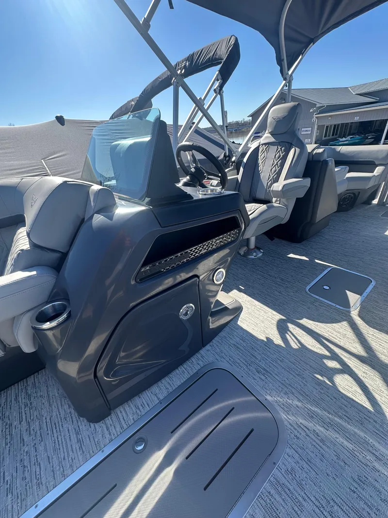 Slide: The Image of 2025 Bennington 24 MFB boat interior with modern helm and seating under canopy. - 10