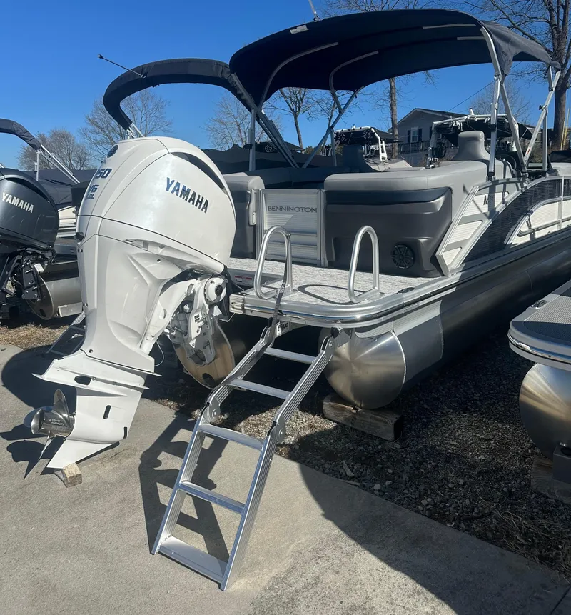 Slide: The Image of 2025 Bennington 24 MFB pontoon boat with Yamaha outboard motor and boarding ladder. - 4