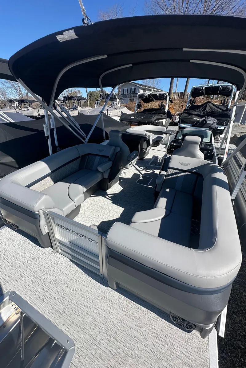 Slide: The Image of 2025 Bennington 24 MFB pontoon boat with spacious seating and canopy, ideal for leisure cruising. - 7