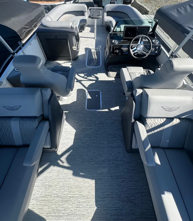 Slide: The Image of 2025 Bennington 24 MFB boat interior with luxurious seating and modern dashboard. - 8