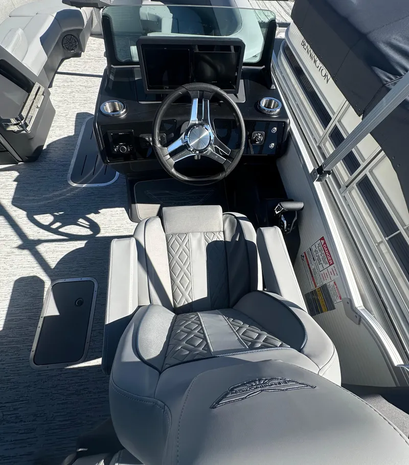 Slide: The Image of 2025 Bennington 24 MFB boat interior with steering wheel and luxurious seating. - 9