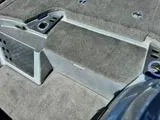 Slide: The Image of 2017 Tracker Nitro Z19 boat interior with gray carpet and storage compartments. - 15