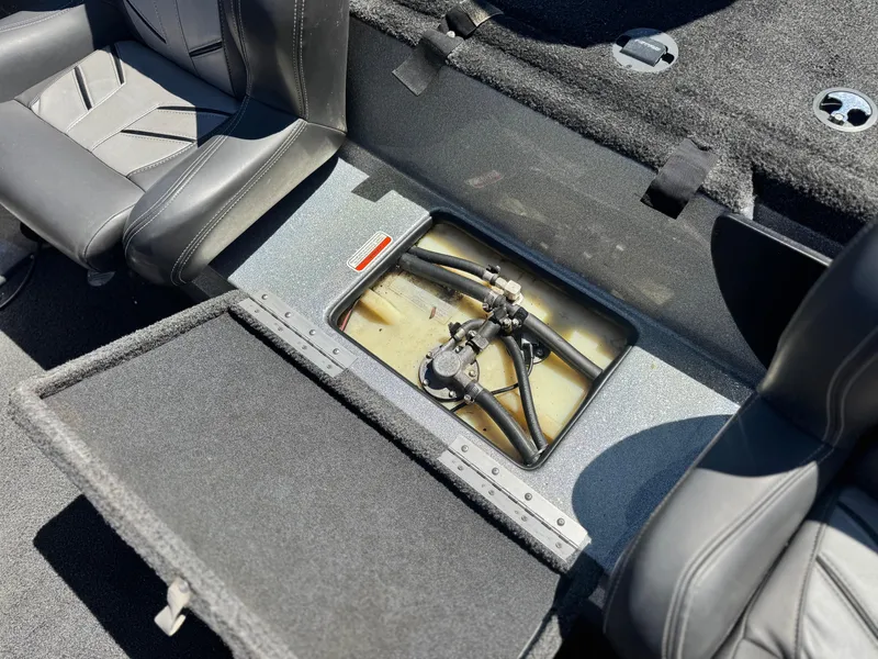Slide: The Image of 2017 Tracker Nitro Z19 boat interior showing open storage compartment and seating. - 18