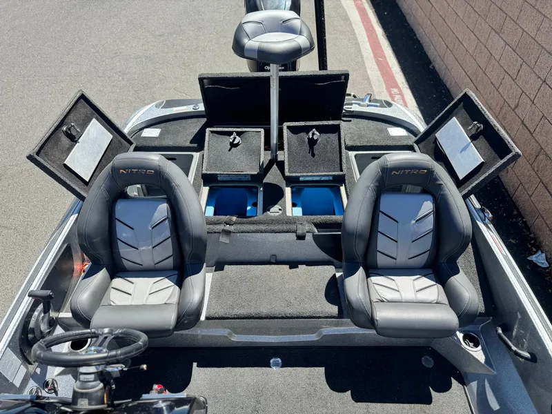 Slide: The Image of 2017 Tracker Nitro Z19 boat interior with two seats and open storage compartments. - 19