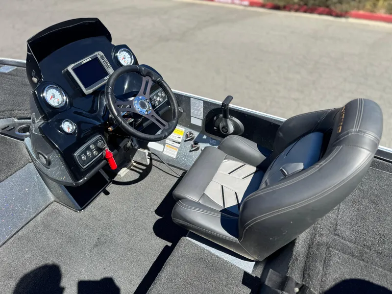 Slide: The Image of 2017 Tracker Nitro Z19 boat cockpit with steering wheel, gauges, and comfortable seat. - 22