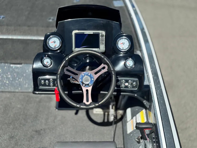 Slide: The Image of 2017 Tracker Nitro Z19 boat dashboard with steering wheel and gauges. - 23