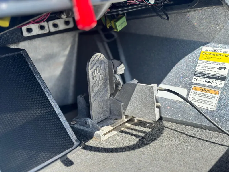 Slide: The Image of Foot pedal and warning label inside 2017 Tracker Nitro Z19 boat cockpit. - 24