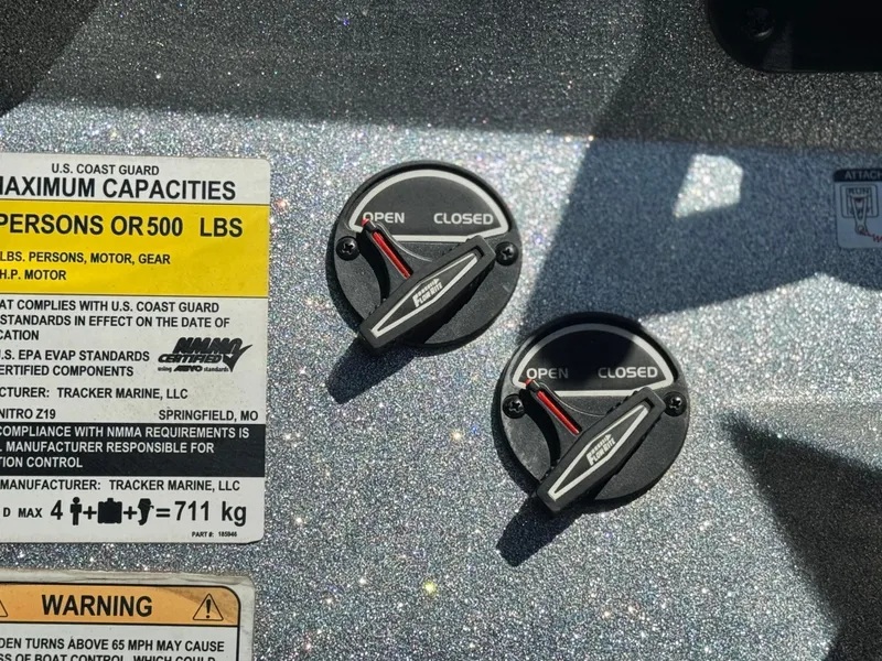 Slide: The Image of 2017 Tracker Nitro Z19 boat capacity and control panel with open/closed switches. - 26