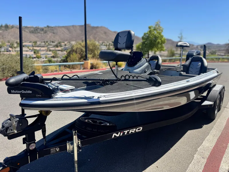 Slide: The Image of 2017 Tracker Nitro Z19 boat with MotorGuide trolling motor on a sunny day. - 3