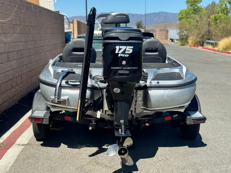 Slide: The Image of 2017 Tracker Nitro Z19 boat with 175 Pro motor, parked on a sunny street. - 4
