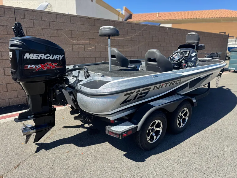 Slide: The Image of 2017 Tracker Nitro Z19 boat with Mercury Pro XS engine, parked outdoors. - 5