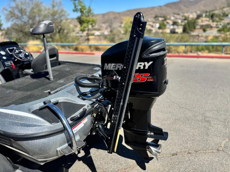 Slide: The Image of 2017 Tracker Nitro Z19 boat with Mercury Pro XS engine, parked on a sunny day. - 7