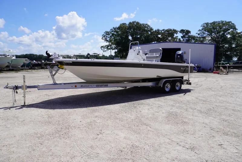Slide: The Image of 2014 NauticStar 244 XTS boat on trailer in outdoor storage area. - 1