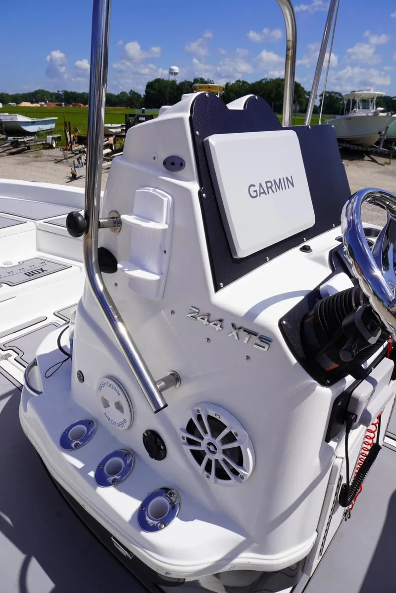 Slide: The Image of 2014 NauticStar 244 XTS boat console with Garmin navigation system under a clear sky. - 11
