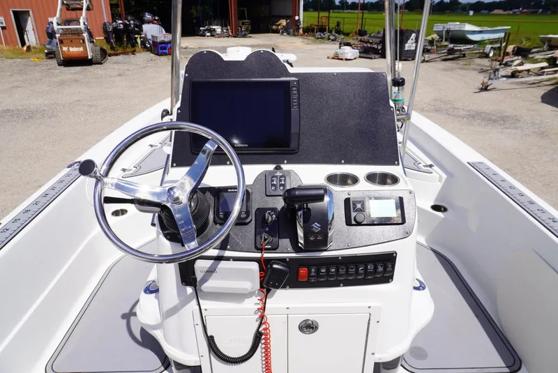 Slide: The Image of 2014 NauticStar 244 XTS boat console with steering wheel and navigation controls. - 12