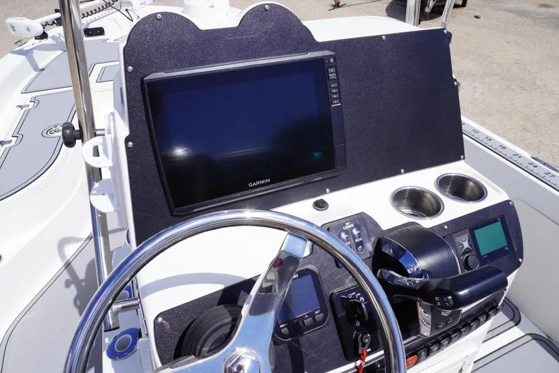 Slide: The Image of 2014 NauticStar 244 XTS boat dashboard with Garmin display and steering wheel. - 14