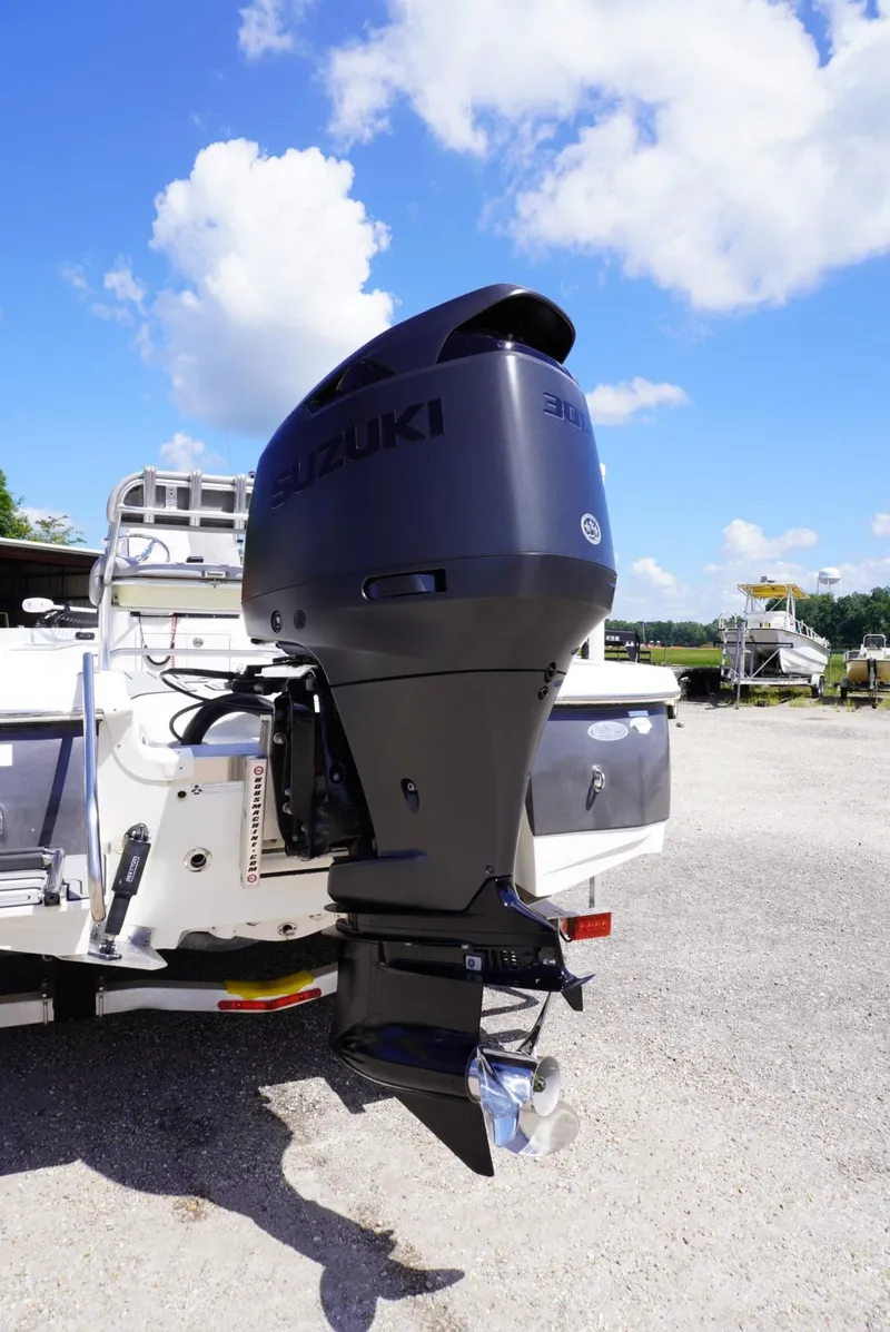 Slide: The Image of 2014 NauticStar 244 XTS boat with Suzuki outboard motor under a clear blue sky. - 15