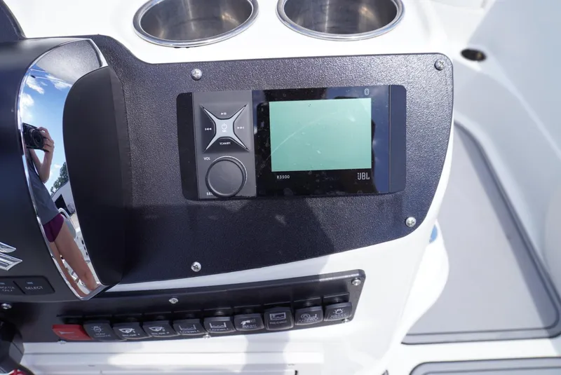 Slide: The Image of Control panel of a 2014 NauticStar 244 XTS boat with JBL audio system. - 17