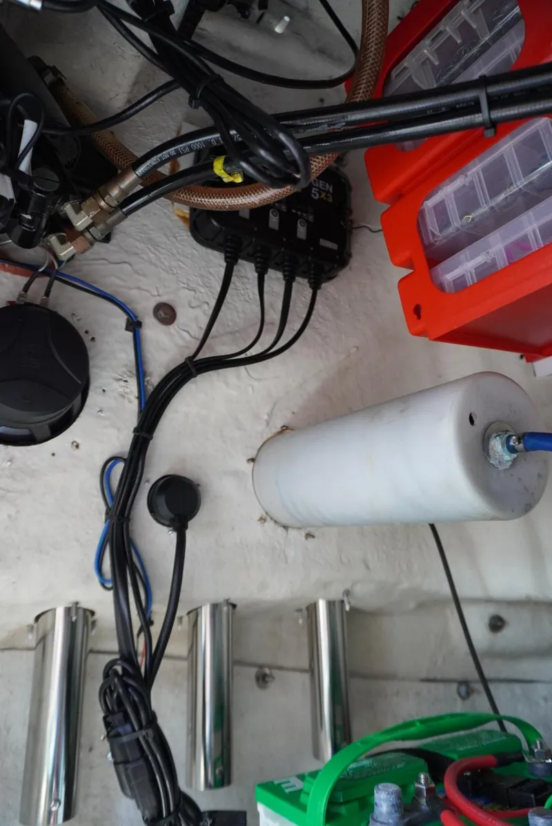 Slide: The Image of 2014 NauticStar 244 XTS boat wiring and components in the engine compartment. - 22