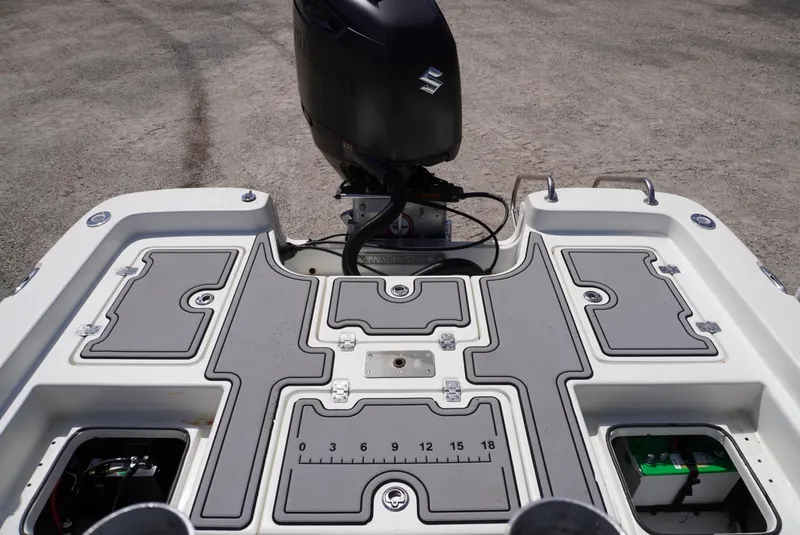Slide: The Image of 2014 NauticStar 244 XTS boat deck with Suzuki outboard motor, featuring storage compartments. - 4