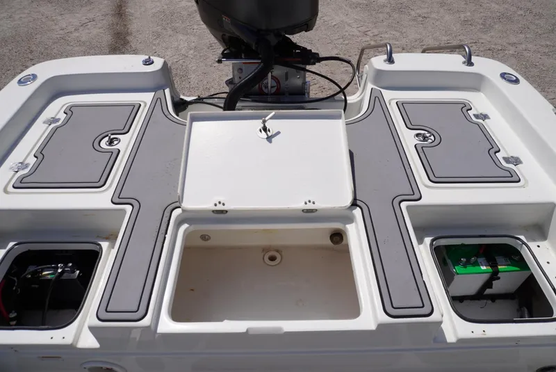 Slide: The Image of 2014 NauticStar 244 XTS boat deck with storage compartments and motor. - 5