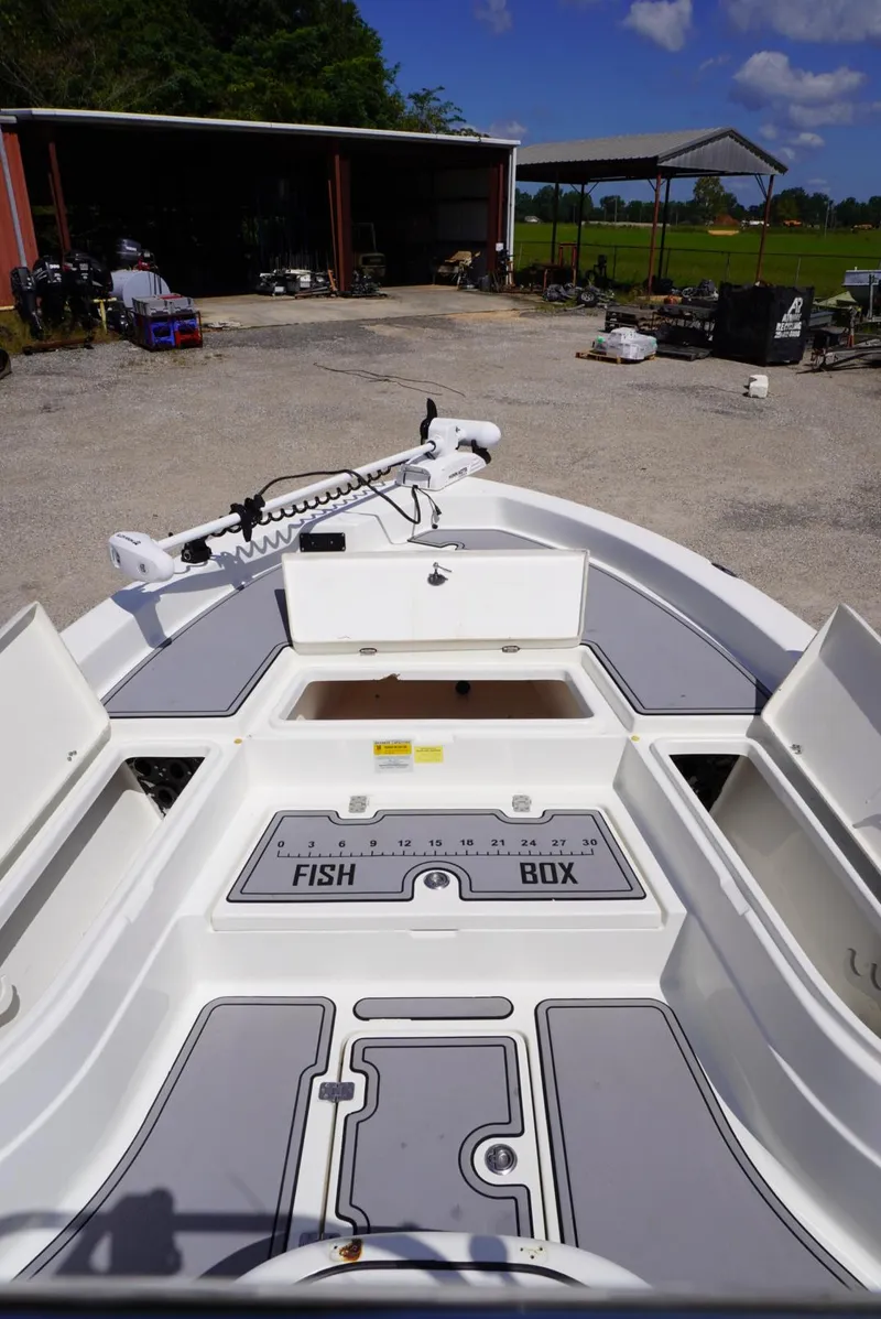 Slide: The Image of 2014 NauticStar 244 XTS boat with open fish box and storage compartments. - 7