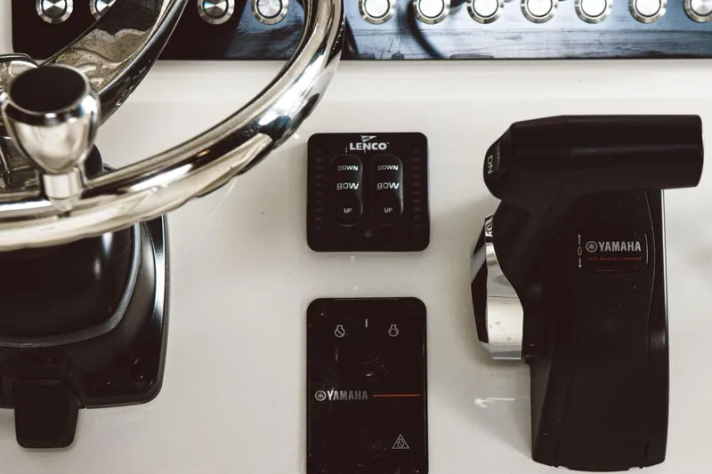 Slide: The Image of 2023 Key West 219 FS boat dashboard with Yamaha controls and Lenco trim tabs. - 10