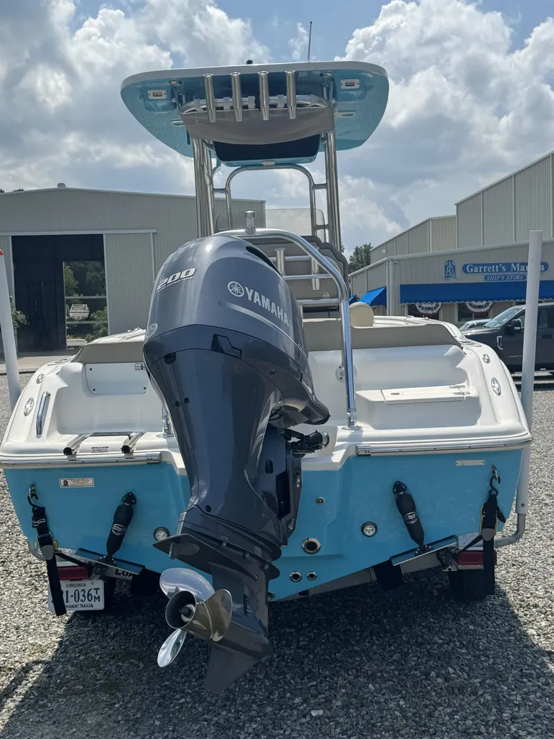Slide: The Image of 2023 Key West 219 FS boat with Yamaha engine, parked outdoors under cloudy sky. - 3
