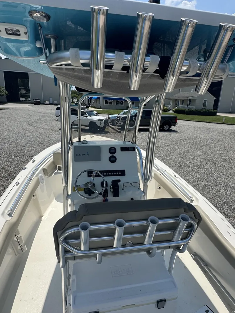 Slide: The Image of 2023 Key West 219 FS boat interior with steering console and rod holders. - 6