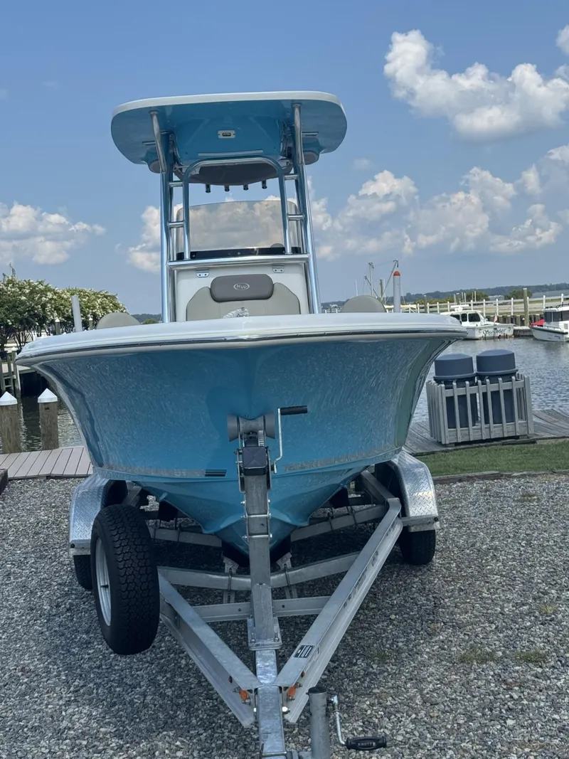 Slide: The Image of 2023 Key West 219 FS boat on trailer by waterfront, under blue sky. - 7