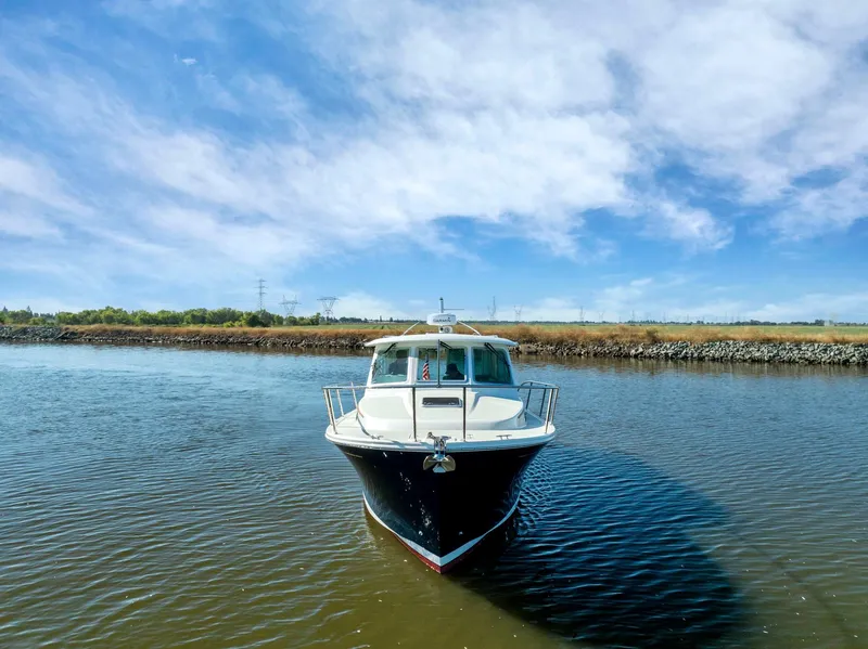 Slide: The Image of 2018 Back Cove 32 boat on calm water under a blue sky. - 20