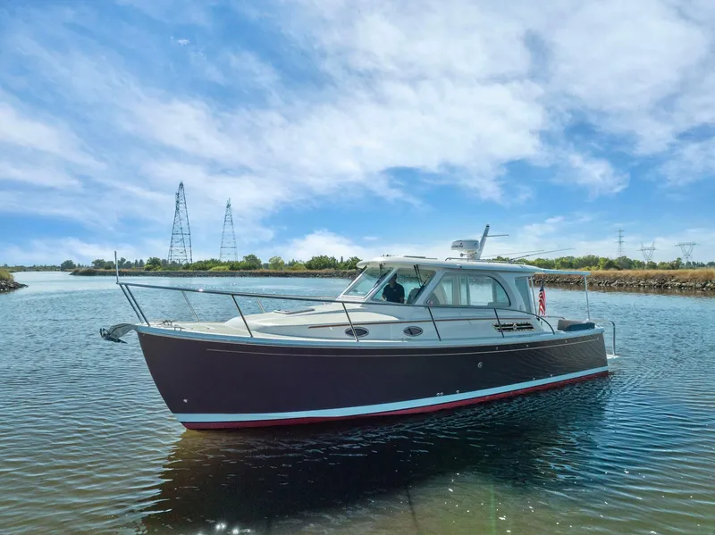 Slide: The Image of 2018 Back Cove 32 boat on calm water under a clear blue sky. - 21