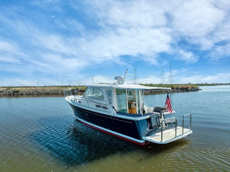 Slide: The Image of 2018 Back Cove 32 boat on calm water under a clear blue sky. - 23