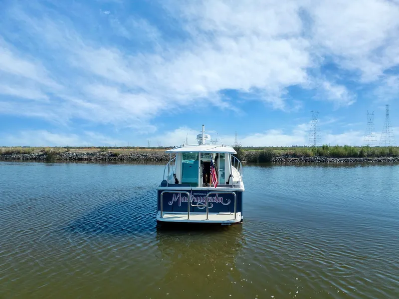 Slide: The Image of 2018 Back Cove 32 boat on calm water under a clear blue sky. - 24