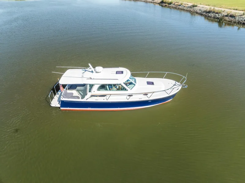 Slide: The Image of 2018 Back Cove 32 boat on calm water, aerial view. - 27