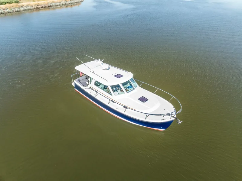 Slide: The Image of 2018 Back Cove 32 boat on calm water, aerial view. - 28