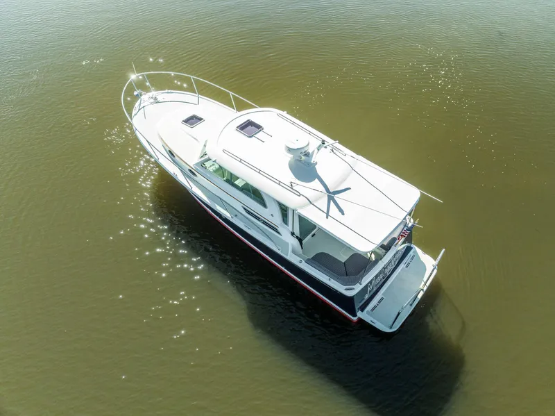 Slide: The Image of 2018 Back Cove 32 boat on calm water, aerial view. - 32
