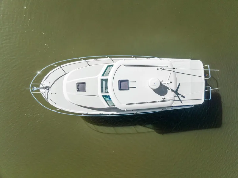 Slide: The Image of Overhead view of 2018 Back Cove 32 boat on calm water. - 33