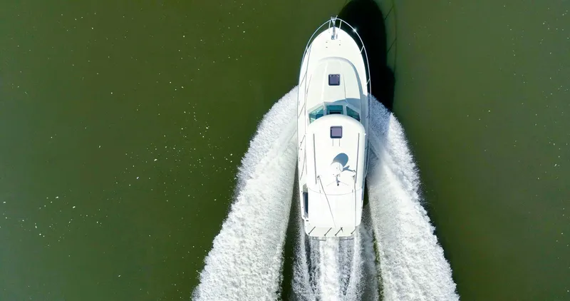 Slide: The Image of Aerial view of 2018 Back Cove 32 boat cruising on water. - 34